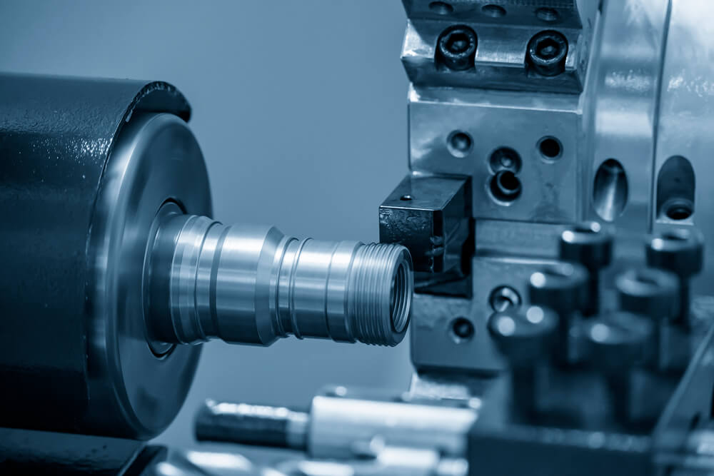 The CNC lathe machine thread cutting at the brass shaft pipe.